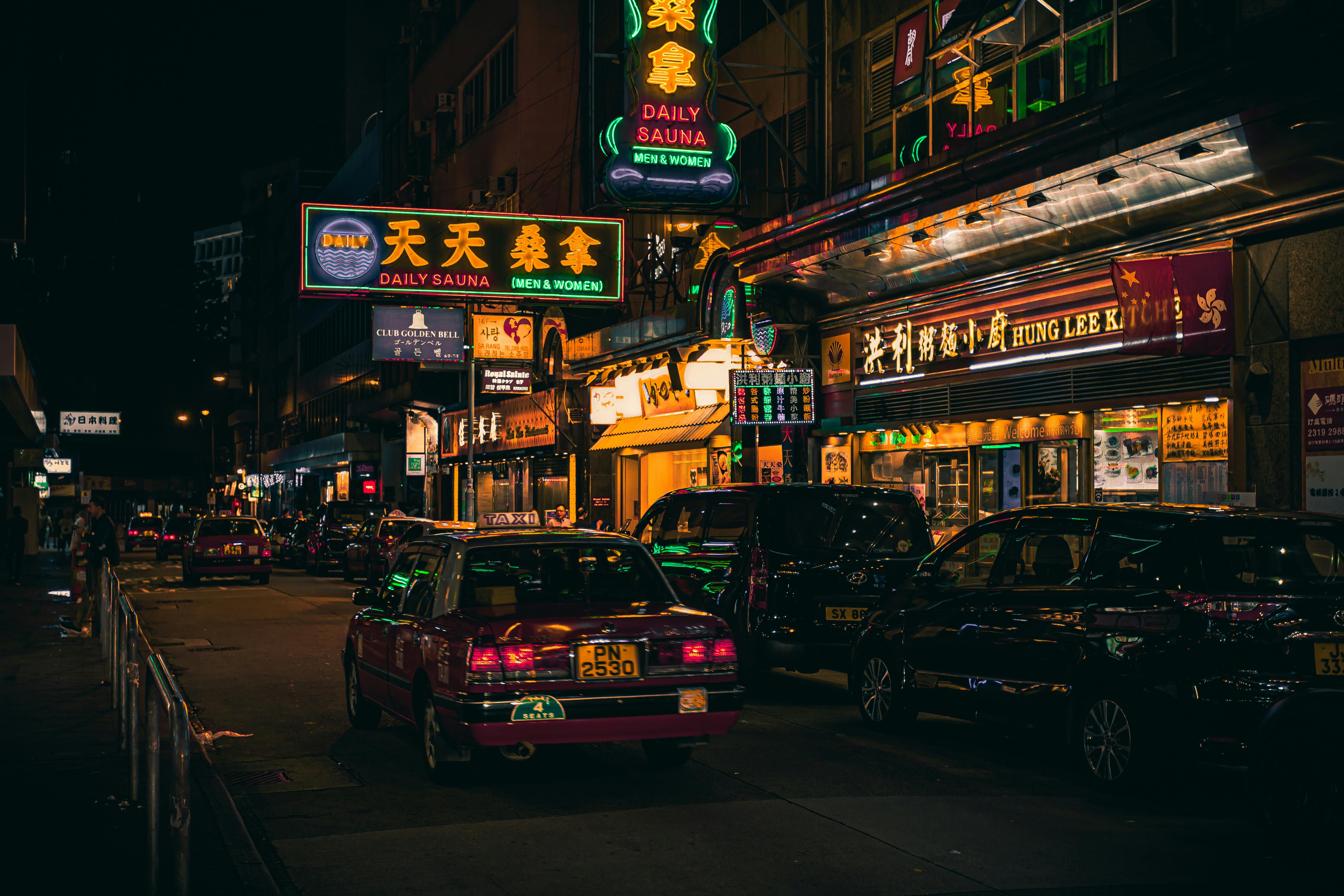Busy Hong Kong street at night with colourful neon signs overhead