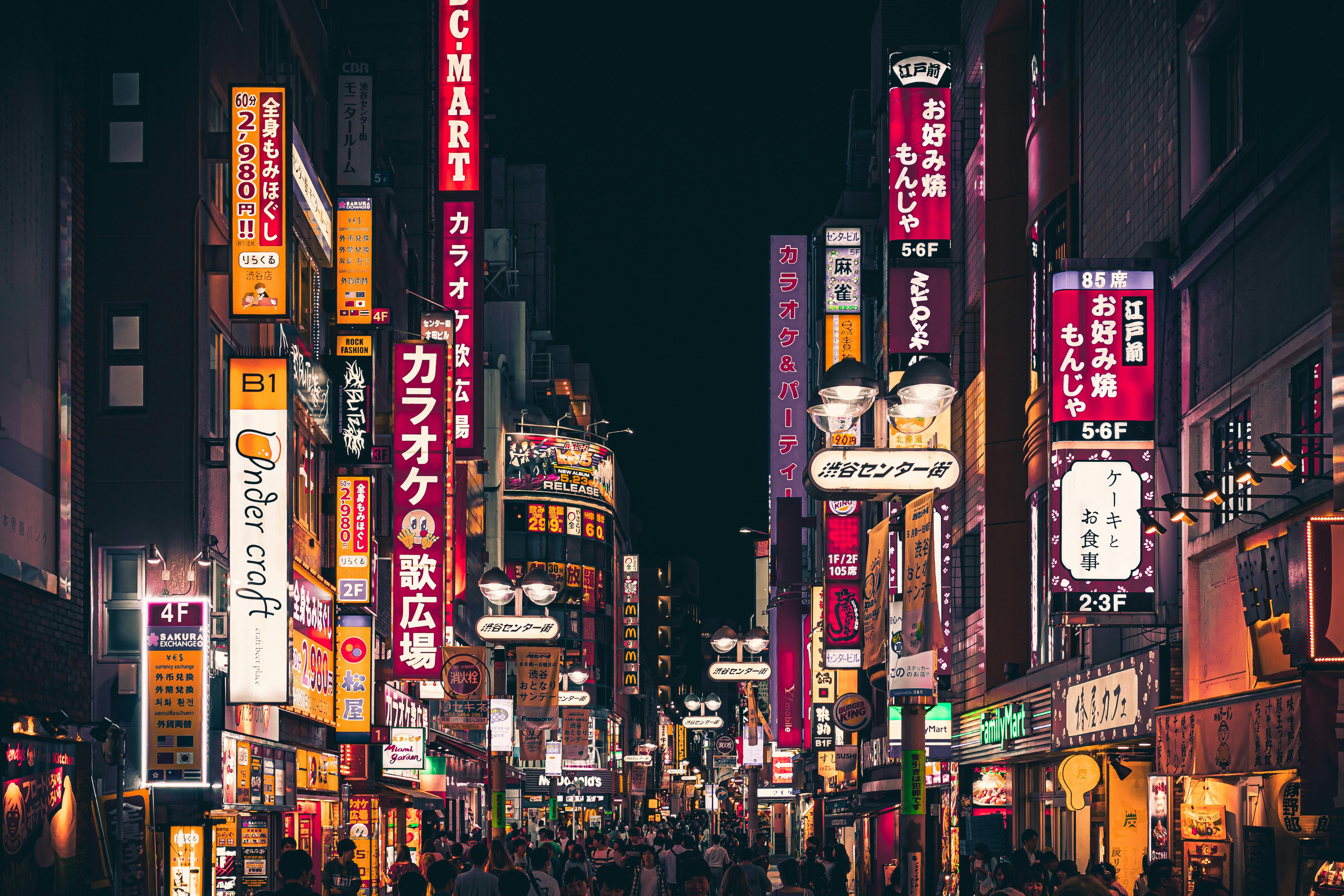 Neon-lit Shibuya shopping street in Tokyo at night
