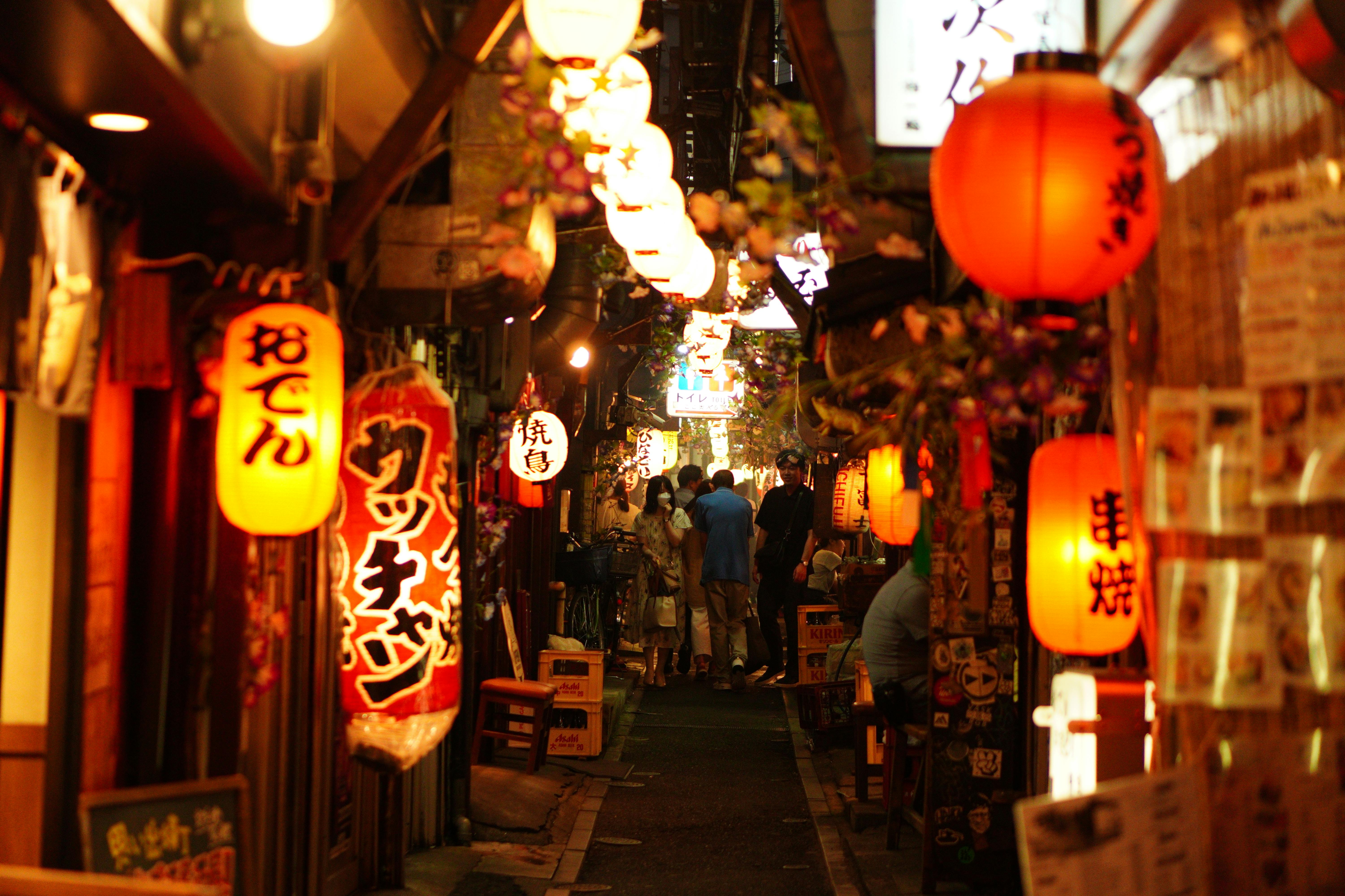 Glowing paper lanterns floating along a river at dusk