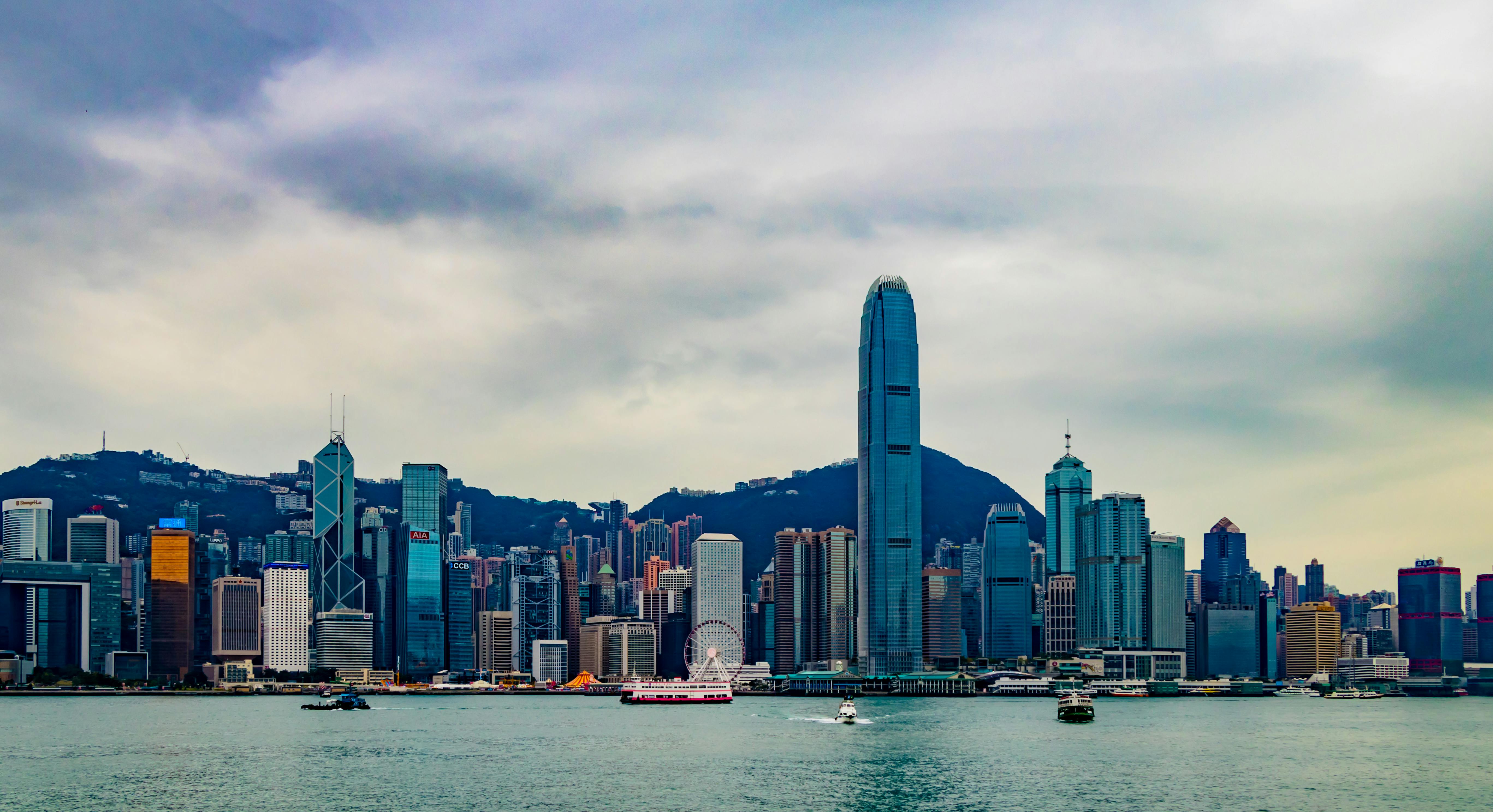 Hong Kong skyline viewed from Victoria Harbour under dramatic sky